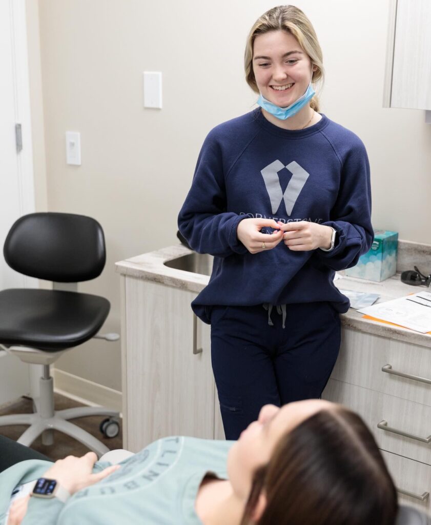 Cornerstone Dental Arts hygienist warmly greeting a patient in a modern Knoxville dental office