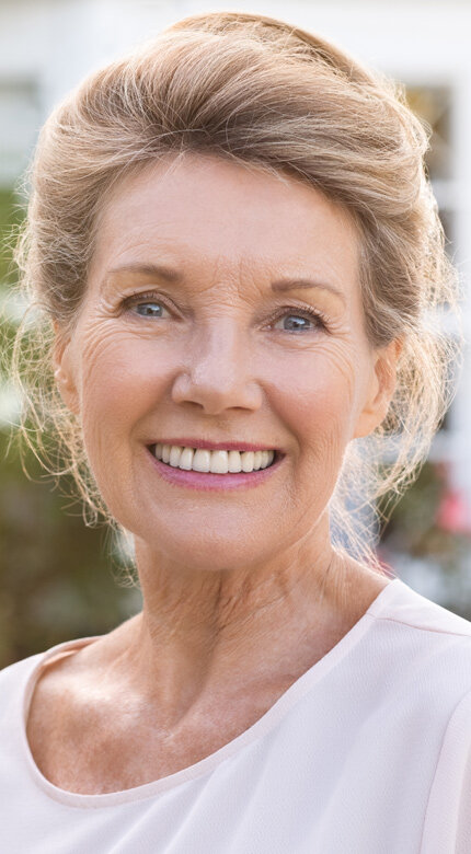 Mature woman with light hair smiling naturally outdoors — Cornerstone Dental Arts smile gallery Knoxville TN