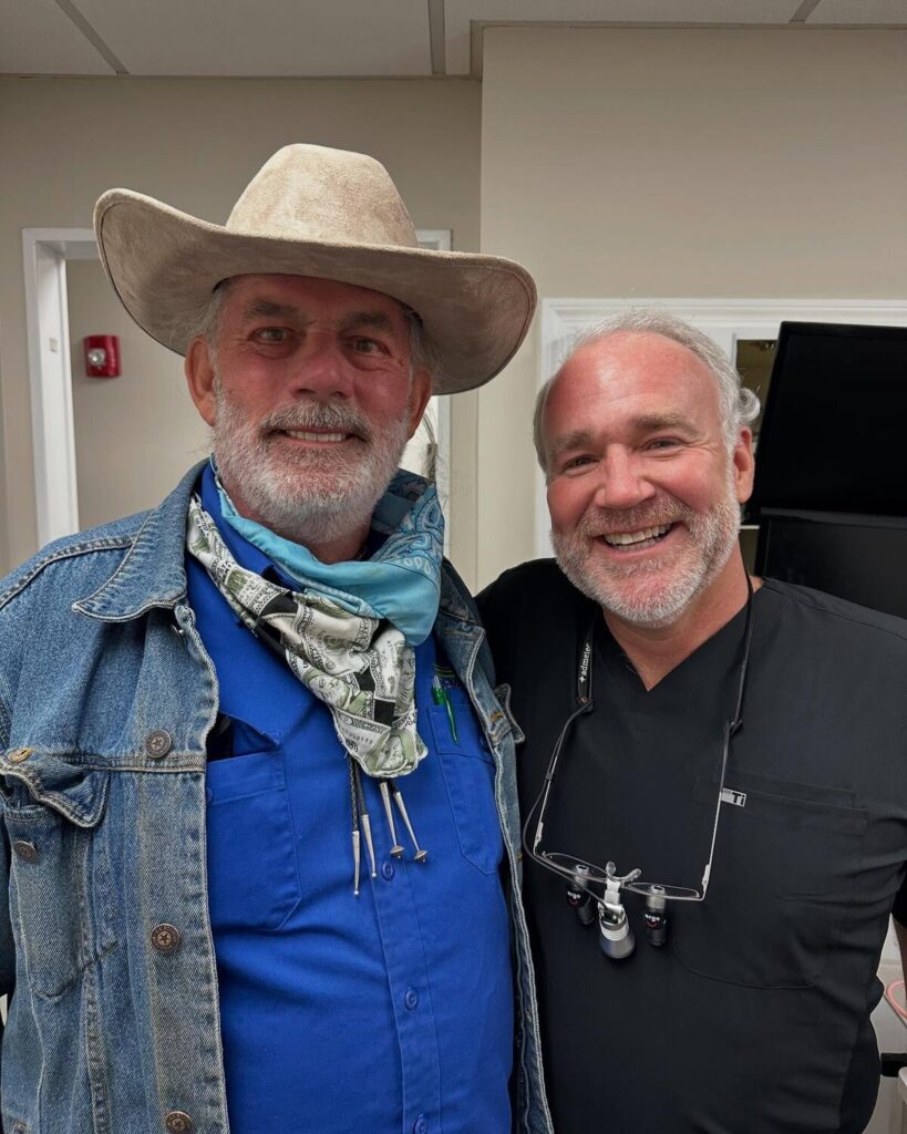 Older male patient in cowboy hat smiling with Dr. Jody F. Griffin at Cornerstone Dental Arts Knoxville TN
