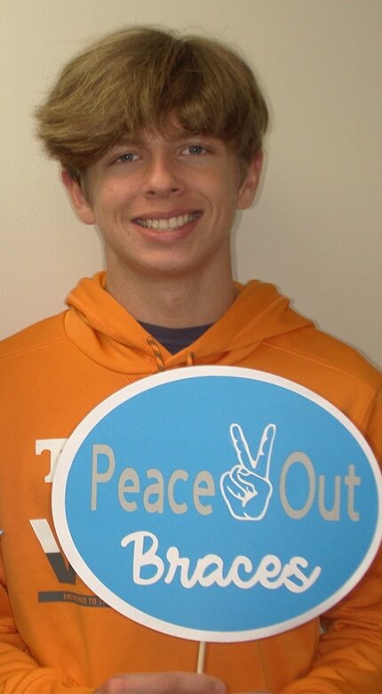 Teen patient holding 'My dentists rocks' sign at Cornerstone Dental Arts, Knoxville, TN