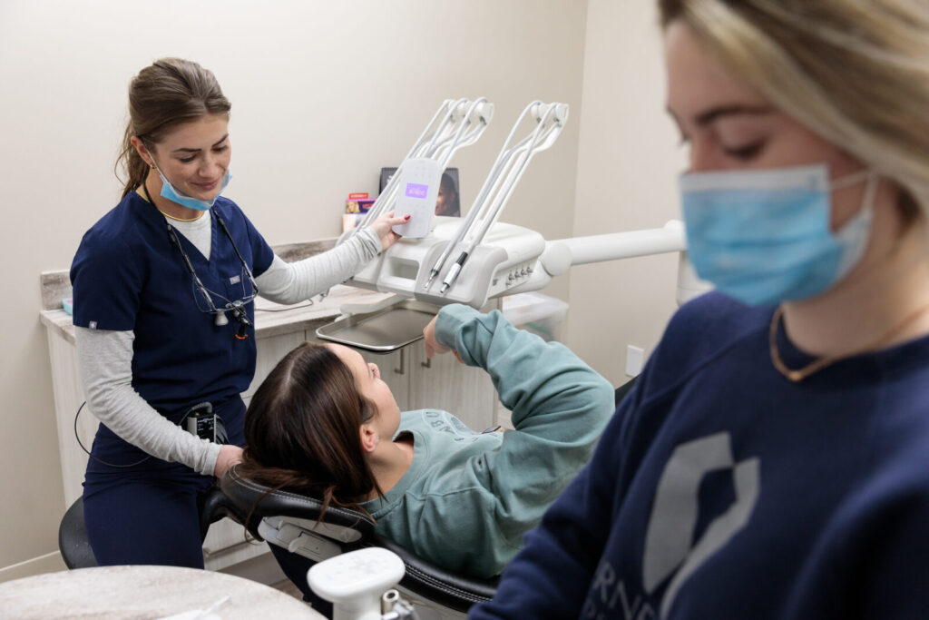 A Cornerstone Dental Arts hygienist treating a young patient in a modern operatory in Knoxville, TN